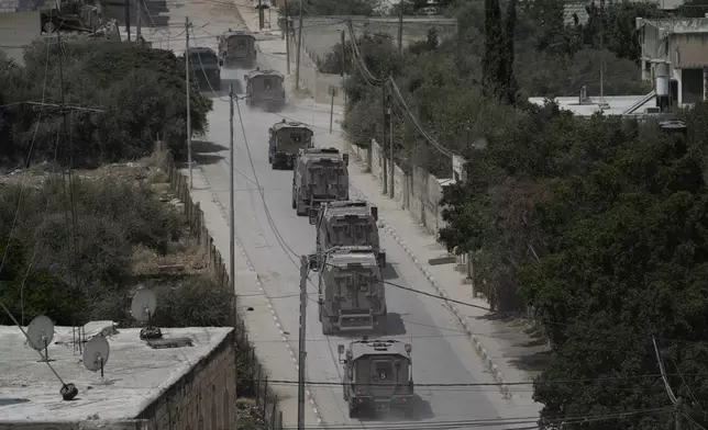 Israeli armoured vehicles move during a military operation in the West Bank Jenin refugee camp, Saturday, Aug. 31, 2024. (AP Photo/Majdi Mohammed)