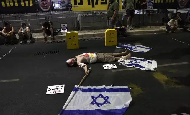 People protest Israeli Prime Minister Benjamin Netanyahu's government and call for the release of hostages held in the Gaza Strip by the Hamas militant group, in Tel Aviv, Israel, Saturday, Aug. 10, 2024. (AP Photo/Mahmoud Illean)