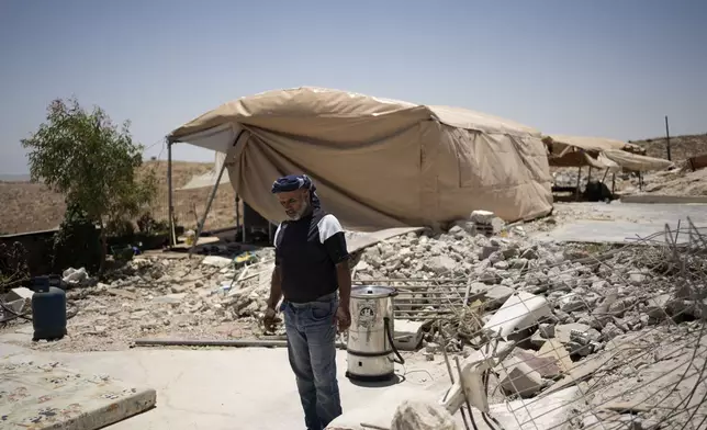 FILE - Yasser Hathaleen stands in the ruins of his family home in the West Bank village of Umm al-Khair, on July 10, 2024. (AP Photo/Maya Alleruzzo, File)