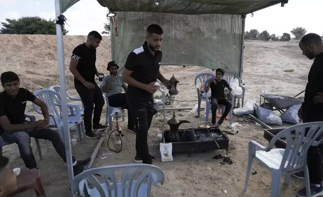 Relatives and friends of Qaid Farhan Alkadi, 52, who was held hostage by Hamas militants in Gaza Strip, wait for his arrival on an area in the Khirbet Karkur village, near Rahat, southern Israel, Wednesday, Aug. 28, 2024. (AP Photo/Mahmoud Illean)