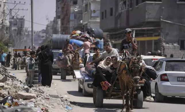 Palestinians evacuate Maghazi refugee camp in the central Gaza Strip, as part of a mass evacuation ordered by the Israeli military ahead of an operation, Saturday, Aug. 17, 2024. (AP Photo/Abdel Kareem Hana)