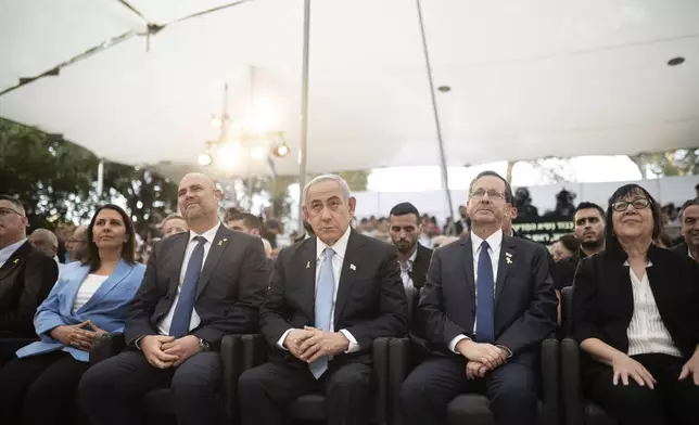 Israeli Prime Minister Benjamin Netanyahu, center, sits with Knesset Speaker Amir Ohana, left, and President Isaac Herzog, center right, at the state memorial for Ze'ev Jabotinsky, at Mount Herzl Military Cemetery in Jerusalem, Sunday, Aug. 4, 2024. (Naama Grynbaum/Pool Photo via AP)