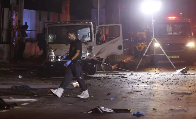 Israeli police work at the scene of a bomb explosion in Tel Aviv, Israel, Sunday, Aug. 18, 2024. Israeli police say one person was killed and another moderately injured. (AP Photo/Moti Milrod)