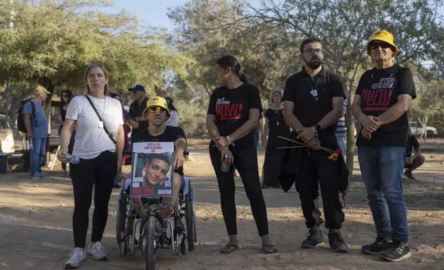 Mourners attend the funeral of Avraham Munder, who was killed in Hamas captivity in the Gaza Strip and recovered by the Israeli military in Gaza, at Kibbutz Nir Oz, southern Israel, Wednesday, Aug. 21, 2024. On Tuesday, the Israeli military said its forces recovered six bodies of hostages kidnapped on Oct. 7 in an overnight operation in southern Gaza. (AP Photo/Ohad Zwigenberg)