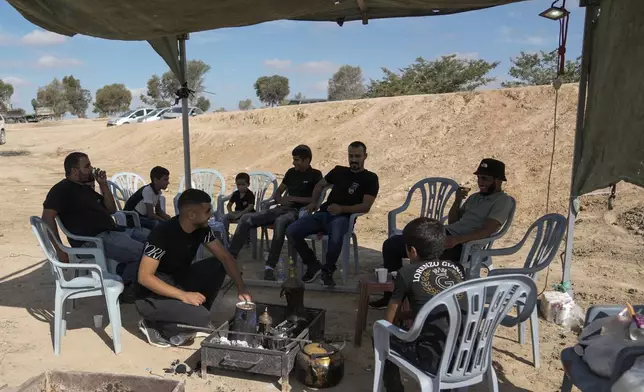 Relatives and friends of Qaid Farhan Alkadi, 52, who was held hostage by Hamas militants in Gaza Strip, wait for his arrival on an area in the Khirbet Karkur village, near Rahat, southern Israel, Wednesday, Aug. 28, 2024. (AP Photo/Mahmoud Illean)