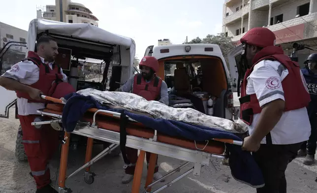 Paramedics carry the body of Ayed Abu Al-Hija, 64, a Palestinian who died during a military operation in the West Bank refugee camp of Nur Shams, Tulkarem, Thursday, Aug. 29, 2024. (AP Photo/Majdi Mohammed)