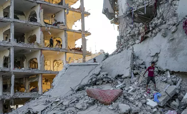 Palestinians inspect their houses after it was destroyed by the Israeli bombardment on east of Deir al-Balah, Thursday, Aug. 29, 2024. (AP Photo/Abdel Kareem Hana)