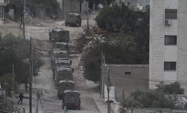 Israeli armoured vehicles move during a military operation in the West Bank Jenin refugee camp, Saturday, Aug. 31, 2024. (AP Photo/Majdi Mohammed)