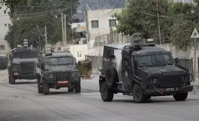 Israeli armoured vehicles move on a street during a military operation in the West Bank city of Jenin, Wednesday, Aug. 28, 2024. (AP Photo/Majdi Mohammed)