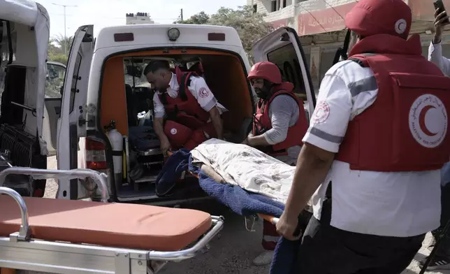 Paramedics carry the body of Ayed Abu Al-Hija, 64, a Palestinian who died during a military operation in the West Bank refugee camp of Nur Shams, Tulkarem, Thursday, Aug. 29, 2024. (AP Photo/Majdi Mohammed)