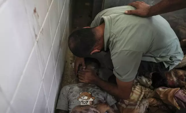 A Palestinian man mourns a relative killed in the Israeli bombardment of the Gaza Strip, at a hospital in Deir al-Balah, Tuesday, Aug. 27, 2024. (AP Photo/Abdel Kareem Hana)