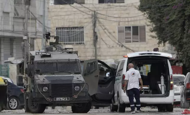 Members of the Israeli forces inside an armoured vehicle check an ambulance during a military operation in the West Bank city of Jenin, Wednesday, Aug. 28, 2024. (AP Photo/Majdi Mohammed)