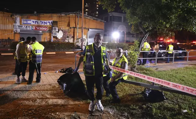 An Israeli ZAKA volunteer works at the scene of a bomb explosion in Tel Aviv, Israel, Sunday, Aug. 18, 2024. Israeli Police say one person was killed and another moderately injured. (AP Photo/Moti Milrod)