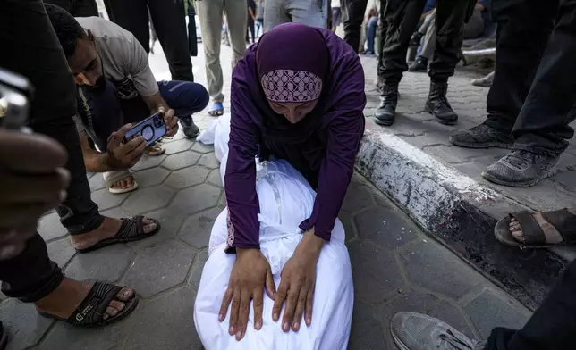 A Palestinian woman mourns a relative killed in the Israeli bombardment of the Gaza Strip at a hospital in Deir al-Balah, Friday, Aug. 30, 2024. (AP Photo/Abdel Kareem Hana)