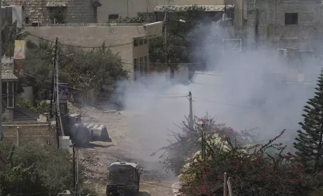 Smoke rises after an explosion during an Israeli military operation in the West Bank Jenin refugee camp, Saturday, Aug. 31, 2024. (AP Photo/Majdi Mohammed)