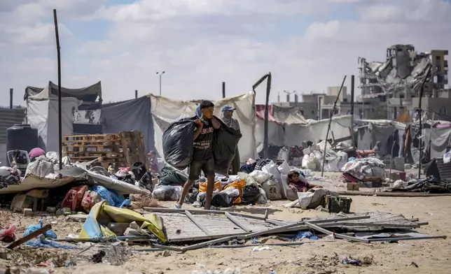 Palestinians displaced by the Israeli air and ground offensive on the Gaza Strip flee from Hamad City, following an evacuation order by the Israeli army to leave parts of the southern area of Khan Younis, Sunday, Aug. 11, 2024. (AP Photo/Abdel Kareem Hana)