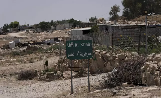 FILE - Caravans and simple structures for residents of the West Bank Bedouin village of Umm al-Khair, are seen at the entrance on July 10, 2024. (AP Photo/Maya Alleruzzo, File)