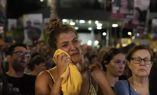 A woman weeps as families of hostages held in the Gaza Strip by Hamas and their supporters gather in Tel Aviv, Israel, Thursday, Aug. 1, 2024 to mark 300 days since their capture on Oct. 7, 2023 by the militant group. (AP Photo/Mahmoud Illean)