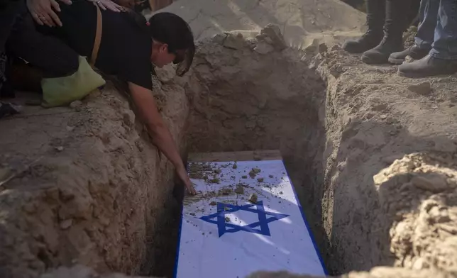 Rimon Buchshtab mourns during the funeral of her husband Yagev Buchshtab at a cemetery of the kibbutz Nirim, southern Israel, Wednesday, Aug. 21, 2024. Buchshtab's body was one the six bodies of hostages, taken in Hamas' Oct. 7 attack, recovered by Israel's military during an operation in the Gaza Strip. (AP Photo/Leo Correa)