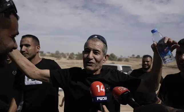 Qaid Farhan Alkadi, 52, who was held hostage by Hamas militants in Gaza Strip, meets his relatives and friends after arriving in the Khirbet Karkur village, near of Rahat, southern Israel, Wednesday, Aug. 28, 2024. (AP Photo/Mahmoud Illean)