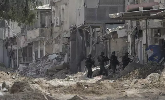 Members of Israeli forces patrol a street during a military operation in the West Bank refugee camp of Nur Shams, Tulkarem, Thursday, Aug. 29, 2024. (AP Photo/Majdi Mohammed)