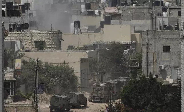 Israeli armoured vehicles move during a military operation in the West Bank Jenin refugee camp, Saturday, Aug. 31, 2024. (AP Photo/Majdi Mohammed)