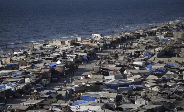 Tents are crammed together as displaced Palestinians camp on the beach, west of Deir al-Balah, Gaza Strip, Tuesday, Aug. 20, 2024. (AP Photo/Abdel Kareem Hana)