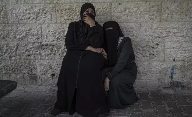 Palestinian women mourn their relatives killed in the Israeli bombardment of the Gaza Strip, at a hospital in Deir al-Balah, Tuesday, Aug. 27, 2024. (AP Photo/Abdel Kareem Hana)