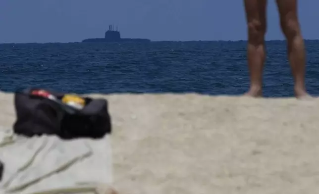 An Israeli submarine, rear, is seen off the coast of Haifa, Israel, Tuesday, Aug. 6, 2024. (AP Photo/Ohad Zwigenberg)