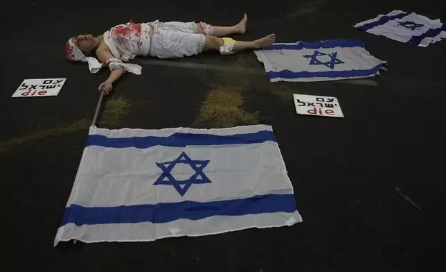 A woman takes part in a protest by relatives of hostages held by Hamas militants in the Gaza Strip and their supporters calling for their immediate release and to protest against Israeli Prime Minister Benjamin Netanyahu's government in Tel Aviv, Israel, Saturday, Aug. 17, 2024. (AP Photo/Tsafrir Abayov)