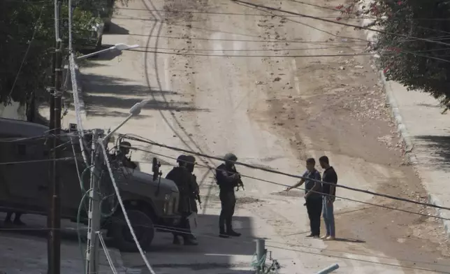 Members of the Israeli forces check Palestinians leaving the West Bank Jenin refugee camp during a military operation, Saturday, Aug. 31, 2024. (AP Photo/Majdi Mohammed)