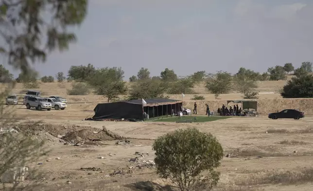 Relatives and friends of Qaid Farhan Alkadi, 52, who was held hostage by Hamas militants in Gaza Strip, wait for his arrival on an area in the Khirbet Karkur village, near Rahat, southern Israel, Wednesday, Aug. 28, 2024. (AP Photo/Mahmoud Illean)