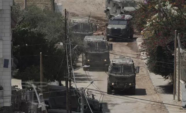 Israeli armoured vehicles move during a military operation in the West Bank Jenin refugee camp, Saturday, Aug. 31, 2024. (AP Photo/Majdi Mohammed)