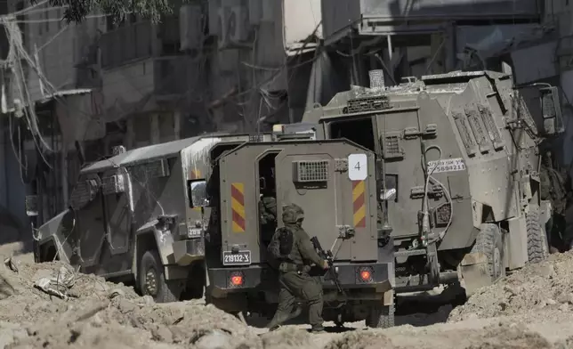 Members of Israeli forces patrol a street during a military operation in the West Bank refugee camp of Nur Shams, Tulkarem, Thursday, Aug. 29, 2024. (AP Photo/Majdi Mohammed)