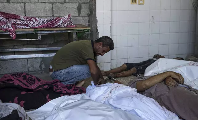 A Palestinian man mourns a relative killed in the Israeli bombardment of the Gaza Strip, at a hospital in Deir al-Balah, Tuesday, Aug. 27, 2024. (AP Photo/Abdel Kareem Hana)