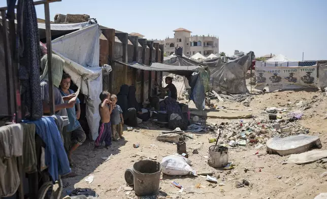 Displaced Palestinians camp on the beach, west of Deir al-Balah, Gaza Strip, Tuesday, Aug. 20, 2024. (AP Photo/Abdel Kareem Hana)