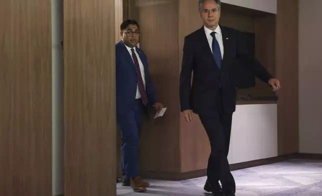 U.S. Secretary of State Antony Blinken, right, walks at the David Kempinski Hotel in Tel Aviv, Israel, Monday, Aug. 19, 2024. (Kevin Mohatt/Pool Photo via AP)