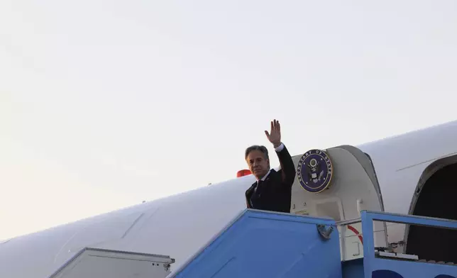 U.S. Secretary of State Antony Blinken waves as he disembarks from his plane in Tel Aviv, Israel, Sunday, Aug. 18, 2024. (Kevin Mohatt/Pool Photo via AP)