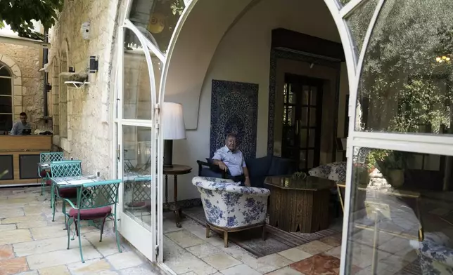 Jeremy Berkovitz, right, the official representative of the owners of the American Colony Hotel, poses for a portrait in east Jerusalem, Sunday, Aug. 18, 2024. As Israel’s economy is suffering from the nearly 11-month war with Hamas, Jerusalem’s iconic American Colony hotel has had to lay off workers and are mulling pay cuts, said Berkovitz. (AP Photo/Mahmoud Illean)