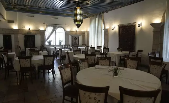 A dining room at the American Colony Hotel in east Jerusalem, Sunday, Aug. 18, 2024. As Israel’s economy is suffering from the nearly 11-month war with Hamas, Jerusalem’s iconic American Colony hotel has had to lay off workers and are mulling pay cuts, said Jeremy Berkovitz, the official representative of the owners. (AP Photo/Mahmoud Illean)