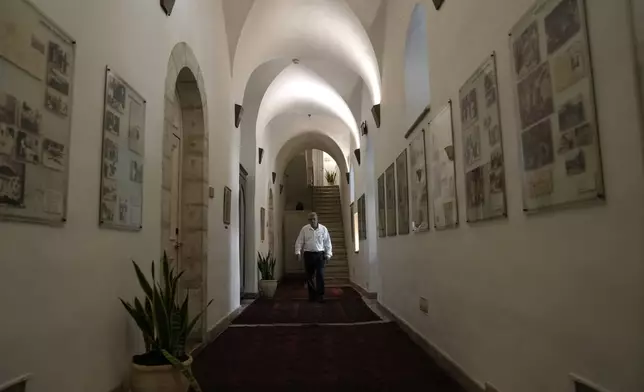 A worker walks in a corridor at the American Colony Hotel in east Jerusalem, Sunday, Aug. 18, 2024. As Israel’s economy is suffering from the nearly 11-month war with Hamas, Jerusalem’s iconic American Colony hotel has had to lay off workers and are mulling pay cuts, said Jeremy Berkovitz, the official representative of the owners. (AP Photo/Mahmoud Illean)