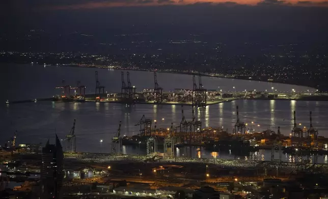 Gantry cranes used to load and unload cargo containers from ships sit stand during the dawn, in the port of Haifa, Israel, Thursday, Aug. 15, 2024. (AP Photo/Leo Correa)