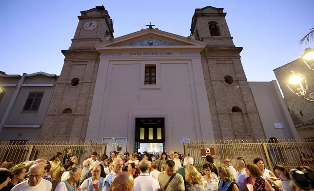 People gather outside the church as Don Vincenzo the parish priest of Porticello in the municipality of Santa Flavia, celebrated mass for the victims of the Bayesian shipwreck in Porticello, Italy, Sunday, Aug. 25, 2024. (Alberto Lo Bianco/LaPresse via AP)