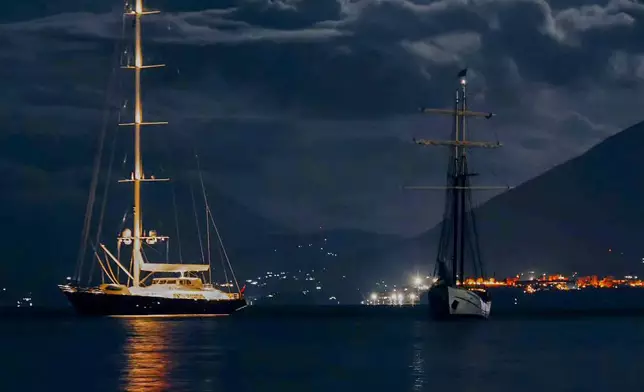 This picture taken at around 20.00gmt on Sunday, Aug. 18, 2024, shows the UK's vessel Bayesan, left, and the Duch sailboat Sir Robert Baden Powell at anchor off the Sicilian village of Porticello near Palermo, in southern Italy, The Bayesan sunk at around 02.00gmt when a violent sudden storm hit the area. 15 people were initially rescued by the crew of the Sir Robert Baden Powell. (Fabio La Bianca/Baia Santa Nicolicchia via AP)