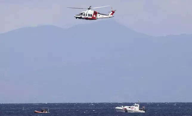 Emergency services at the scene of the search for a missing boat, in Porticello Santa Flavia, Italy, Monday, Aug. 19, 2024. British tech giant Mike Lynch, his lawyer and four other people are among those missing after their luxury superyacht sank during a freak storm off Sicily, Italy’s civil protection and authorities said. Lynch’s wife and 14 other people survived. (Alberto Lo Bianco /LaPresse via AP)