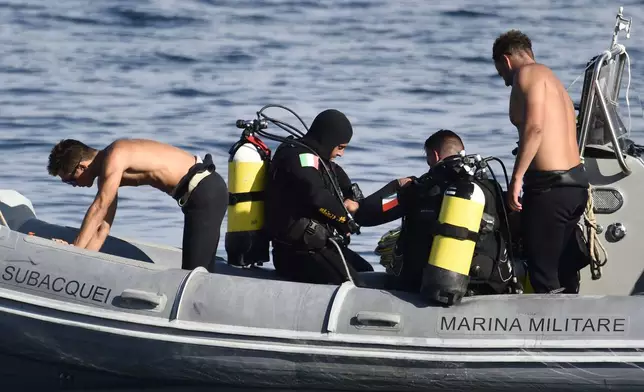 Italian Navy scuba divers work at the scene of the search for a missing boat, in Porticello, southern Italy, Thursday, Aug. 22, 2024. Rescue teams and divers returned to the site of a storm-sunken super yacht to search for one person, who are believed to be still trapped in the hull 50 meters (164-feet) underwater. (AP Photo/Salvatore Cavalli)