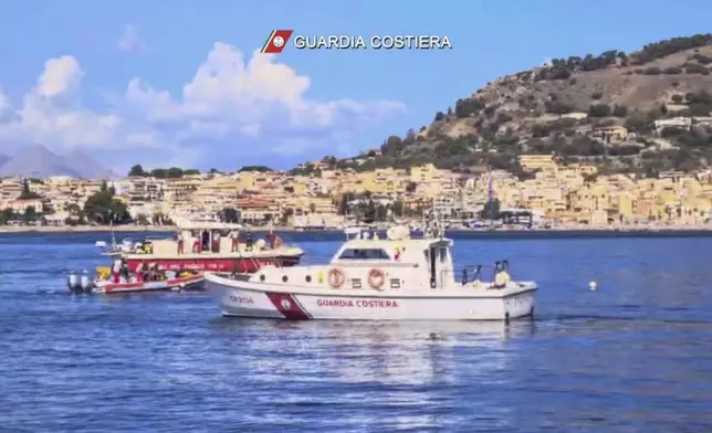 This picture taken from video released by the Italian Coast Guard on Monday, Aug. 19, 2024, shows the rescue operations in the stretch of Sea near Palermo, Sicily, in southern Italy, where the sail yacht Bayasian under UK flag sank early Monday. (Italian Coast Guard via AP, HO)