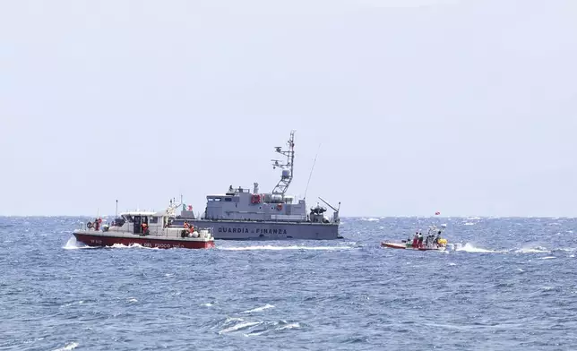 Emergency services at the scene of the search for a missing boat, in Porticello Santa Flavia, Italy, Monday, Aug. 19, 2024. British tech giant Mike Lynch, his lawyer and four other people are among those missing after their luxury superyacht sank during a freak storm off Sicily, Italy’s civil protection and authorities said. Lynch’s wife and 14 other people survived. (Alberto Lo Bianco /LaPresse via AP)