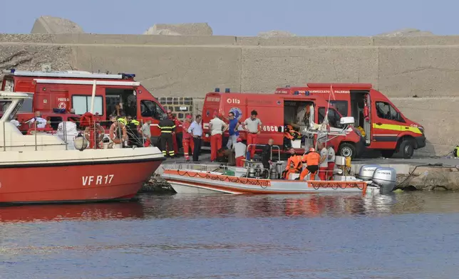 Italian Firefighters scubadivers prepare to sail toward the area where the UK flag vessel Bayesan that was hit by a violent sudden storm, sunk early Monday, Aug. 19, 2024, while at anchor off the Sicilian village of Porticello near Palermo, in southern Italy. (AP Photo/Lucio Ganci)