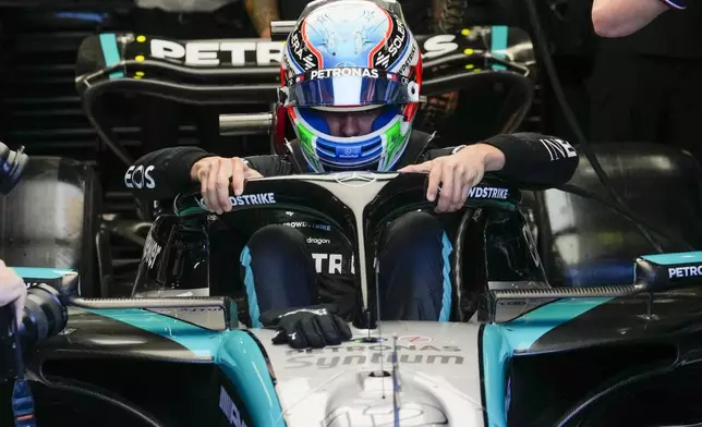 Mercedes driver Andrea Kimi Antonelli of Italy enters his car during the first free practice ahead of the Formula One Italian Grand Prix race at the Monza racetrack, in Monza, Italy, Friday, Aug. 30, 2024. (AP Photo/Luca Bruno)